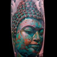 Spectacular looking new school style colored forearm tattoo of Buddha statue