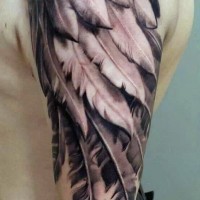 Spectacular natural looking 3D like shoulder tattoo of angel wing