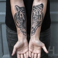 Spectacular painted by Valentin Hirsch forearm tattoo of split tiger face