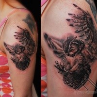 Spectacular realism style colored flying owl tattoo on shoulder