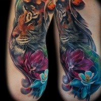 Spectacular realism style tattoo of realistic tiger with flowers