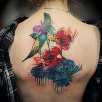 Spectacular watercolor style painted upper back tattoo of bird with flowers