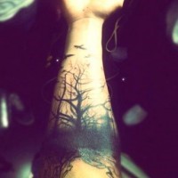 Spooky black tree with birds forearm tattoo