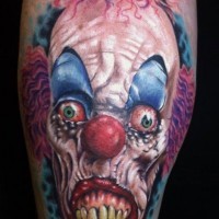 Spooky clown with red eyes tattoo
