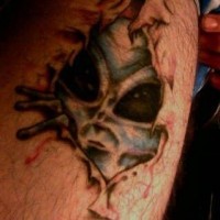 Spooky face alien skin rip tattoo
