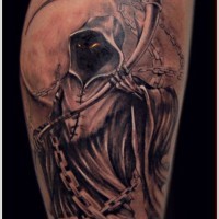Spooky grim reaper with glowing eyes tattoo