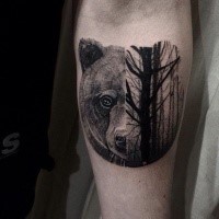 Stippling style black and white forearm tattoo of bear head with dark forest