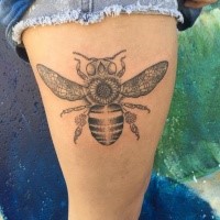 Stippling style black and white thigh tattoo of bee