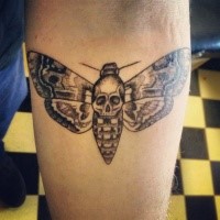 Stippling style black ink arm tattoo of big butterfly with human skull
