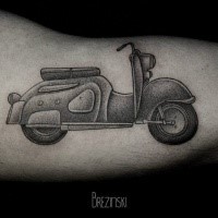 Stippling style black ink biceps tattoo of vintage scoter