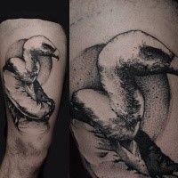 Stippling style black ink bird tattoo on thigh