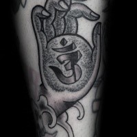Stippling style black ink Buddha hand with symbol tattoo