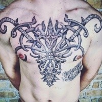 Stippling style black ink chest tattoo of mystical ornaments and lettering