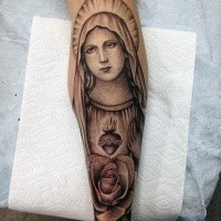 Stippling style black ink forearm tattoo of saint woman with flower