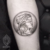 Stippling style black ink forearm tattoo of coin with bling woman