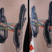 Stippling style black ink forearm tattoo of human hand with multicolored ribbon