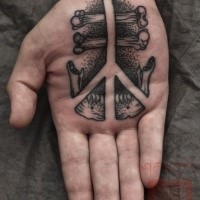Stippling style black ink hand tattoo of pacific symbol with bones