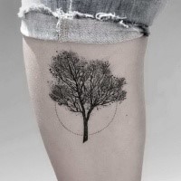 Stippling style black ink leg tattoo of small tree