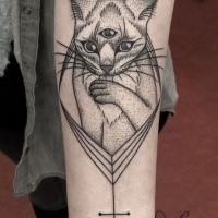 Stippling style black ink shoulder tattoo of mysterious cat with cross