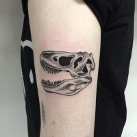 Stippling style black ink shoulder tattoo of dinosaur skull