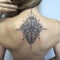 Stippling style black ink upper back tattoo of star