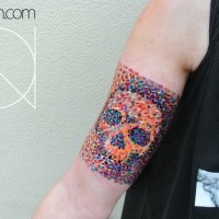 Stippling style colored arm tattoo of human skull