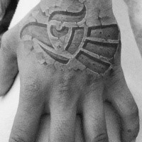 Stonework style black ink hand tattoo of incredible ornament