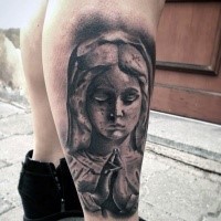 Stonework style black ink leg tattoo of praying woman statue