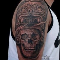 Stonework style colored shoulder tattoo of human skull with demonic helmet