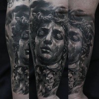 Stonework style detailed arm tattoo of big statue head