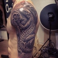 Stonework style detailed shoulder tattoo of big lizard wall statue