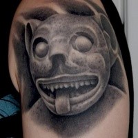 Stonework style shoulder tattoo of ancient demonic statue