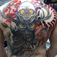 Strange designed colorful owl with deer horns tattoo on back with demonic skull