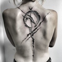 Strange looking black ink by Inez Janiak tattoo on whole back