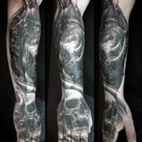 Strange looking black ink human skull tattoo on hand combined with rhino on forearm