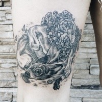 Strange looking black ink thigh tattoo of of small fox and flowers