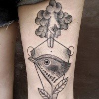 Strange looking black ink thigh tattoo of human hand with bird and leaves