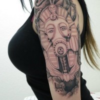 Strange looking colored Egypt pharaoh statue in gas mask tattoo on shoulder