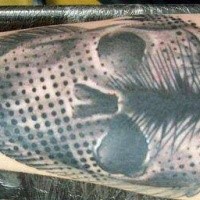 Strange looking colored forearm tattoo of big fish stylized with skull