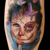 Strange looking colored girl portrait tattoo on with ornaments and butterflies