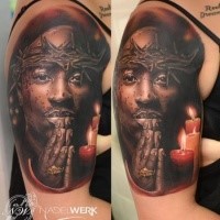 Strange looking colored shoulder tattoo of 2PAC with candle and vine