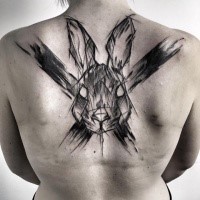 Strange looking sketch style painted by Inez Janiak upper back tattoo of rabbit with big cross