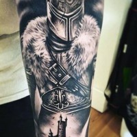 Stunning black and white detailed medieval warrior tattoo on forearm with castle
