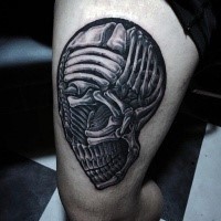 Stunning black and white futuristic looking thigh tattoo of alien skull