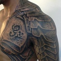 Stunning black ink armor like detailed tattoo on chest and shoulder with lettering