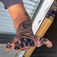 Stunning black ink evil shark tattoo on hand