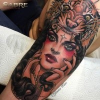 Stunning colored upper arm tattoo of ancient woman with tiger skin helmet by Jenna Kerr