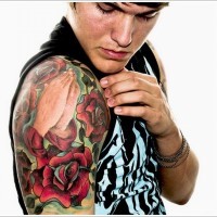 Stunning combined colored praying hands with roses tattoo on shoulder