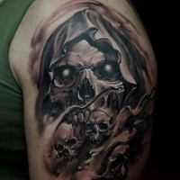 Stunning looking black and gray style shoulder tattoo of demonic skeleton
