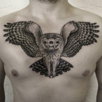 Stunning looking black ink chest tattoo of flying owl with tree eyes
